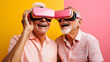 © jcalvera - Senior adult couple having fun together with virtual reality headsets sitting on the couch.Concept of New trends and technology concept