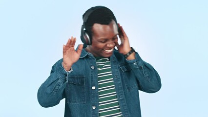 Poster - Music, headphones and excited black man in studio for streaming song, radio and audio. Happy, freedom and person listening to track, dance and move with energy, fun and relax on a blue background