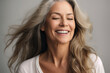 © SageCreations - A Beautiful Mature Woman with Gray Hair on a Gray Background