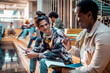 © Marko Geber - Young and diverse group of student friends hanging out in a university lobby