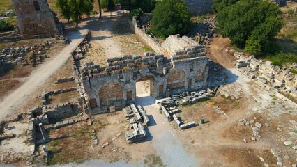 Wall Mural - In this captivating aerial stock video, the remarkable ruins of the ancient city of Perge in conteprorary city of Antalya, Turkey are shown. The camera gracefully glides above, offering a panoramic