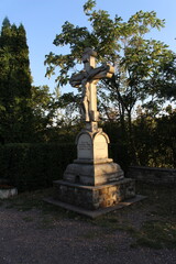 Wall Mural - A statue of a person holding a cross