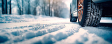 Closeup of car tires in winter on the road covered with snow	
