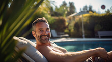 Smiling Man Relaxes At An Expensive Resort With A Private Pool In The Background