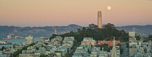 Panoramic of the full moon rise behind the Coit Tower on Telegraph Hill, San Francisco, at sunset; San Francisco, California, United States of America