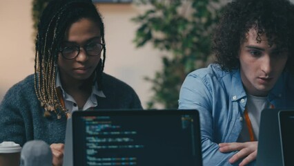 Two happy IT specialists giving each other high five after finishing a project
