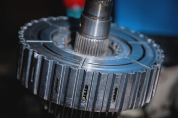 Wall Mural - A close-up of a pack of clutches on a shaft with a gear from an automatic transfer case of a four-wheel drive car. Toned image.