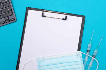 vaccination, immunology or revaccination concept - two medical syringe lying on blue table in doctor