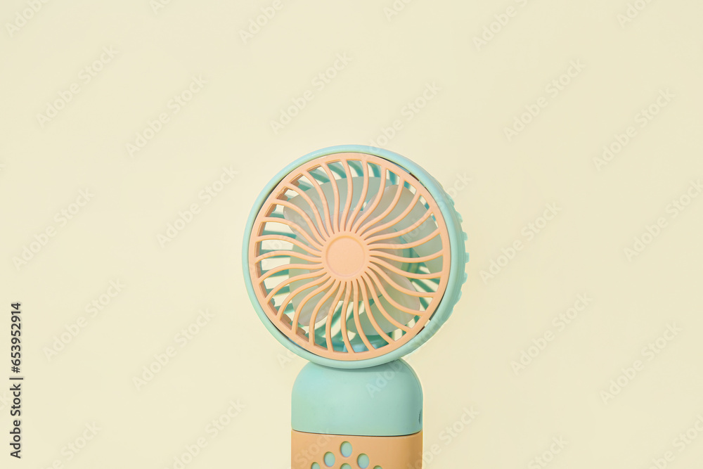 Mini electric fan on color background, closeup