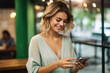 © vefimov - Woman is shown smiling while looking at her cell phone. This image can be used to depict happiness, technology, communication, or social media.