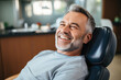 © vefimov - Picture of man sitting in chair with genuine smile. This image can be used to depict happiness, relaxation, or contentment in various settings.