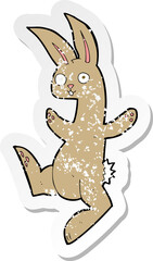  retro distressed sticker of a funny cartoon rabbit