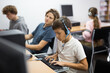 © JackF - Young boy wearing headset while studying in computer class.