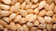 Background of big raw peeled almonds situated arbitrarily
