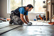 Tile installer, a man laying floor tiles in a new home, demonstrating the expertise and precision of a professional contractor