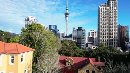 Wall Mural - Auckland, New Zealand: Aerial drone footage of Auckland downtown district skyline view from the Albert park in New Zealand largest city. Shot with an upward motion