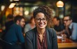 © tongpatong - Portrait of a middle-aged, multiracial LGBTQ entrepreneur in the boardroom, listening to female coworkers.