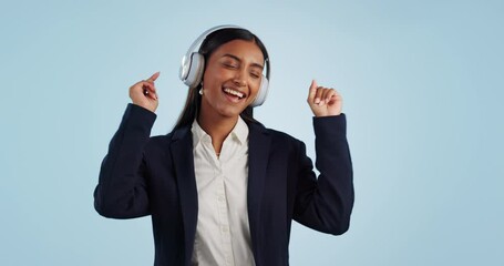 Wall Mural - Dance, music and business woman in studio listening to song, audio and track on streaming subscription. Happy, relax and person with headphones for radio, freedom and broadcast on blue background