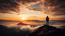Silhouette Of A Man On The Mountain Top Sunset Among The Clouds