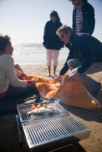 Friends Having A Barbeque On The Beach

