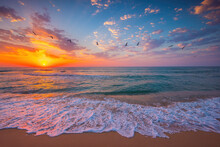 Ocean Sunrise Over Beach Shore And Waves. The Sun Is Rising Up Over Sea Horizon