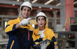 © Nassorn - Hispanic industrial engineers in white helmet and safety jacket working in heavy metal engineering factory. Latin technician workers using tablet computer in metalwork manufacturing facility, portrait
