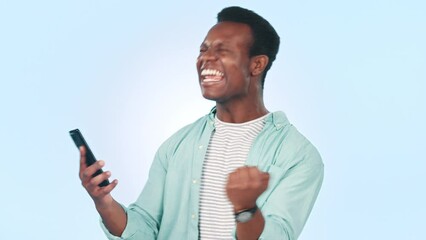 Wall Mural - Black man, smartphone and cheers with fist pump and winning social media giveaway isolated on blue background. Happiness, excited and celebration with online competition, reward and bonus in studio