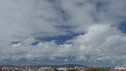 Wall Mural - movement of beautiful clouds in the blue sky over city houses, time lapse video. nice nature backgro