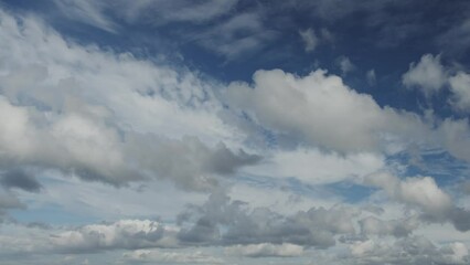 Wall Mural - movement of beautiful clouds in the blue sky over city houses, time lapse video. nice nature backgro
