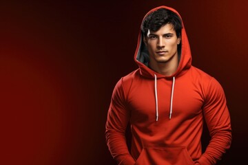 Aufkleber - A man wearing a red hoodie strikes a pose for a photo. This image can be used to depict casual fashion, street style, or urban culture.