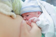 newborn baby breastfed by mother