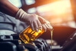 Close-up of professional mechanic in protective gloves pouring the oil