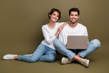 Poster - Full length photo of cute pretty married couple wear white shirts typing modern gadget empty space isolated brown color background