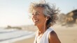 Portrait of a senior woman jogging on the beach background.