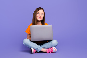 Canvas Print - Full body length cadre of young dreamy cute daughter girl using her laptop apple device browsing trends isolated on purple color background