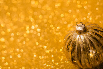 Wall Mural - gold bauble on gold glitter texture. christmas and winter holidays chic background