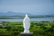 White statue of Saint Patrick at the start of foot path to the peak of Croagh Patrick, county Mayo, Ireland
