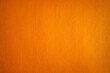 Photo of an orange background texture made of felt fabric. Soft textiles of red color.