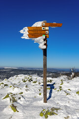 Poster - Signpost in the winter landscape on the top of the Lusen mountain in the Bavarian Forest, Bavaria, Germany.