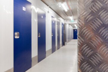 Corridor of self storage unit with blue doors. Rental Storage Units
