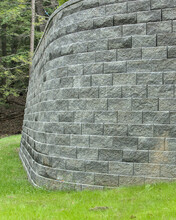 Tall Stone Retaining Wall (curved Brick Masonry) In House Back Yard (large Gray Supporting Structure)