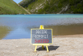 Wall Mural - Decide commit succeed symbol. Concept word Decide Commit Succeed on beautiful black chalk blackboard. Beautiful mountain lake sand beach background. Business decide commit succeed concept. Copy space.