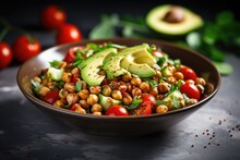 Vegan Salad With Roasted Chickpeas Avocado And Tomatoes In A White Bowl