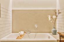 Interior Of Bathroom With Bathtub And Flower Vase At Home