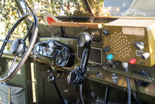 Interior Of An Old Green Military Jeep Covered With Camouflage Netting