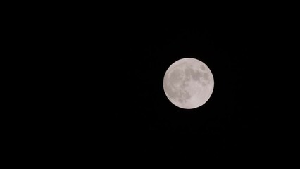 Wall Mural - Zoom out from full moon in a dark sky 