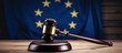 EU flag and wooden gavel on table with text space