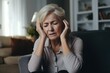 © ChaoticMind - Headache pain, anxiety and senior woman thinking of mental health problem on the living room sofa in house. Sad elderly person with depression, home stress and frustrated with retirement on the couch