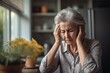© ChaoticMind - Headache pain, anxiety and senior woman thinking of mental health problem on the living room sofa in house. Sad elderly person with depression, home stress and frustrated with retirement on the couch
