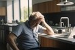 © ChaoticMind - Headache pain. Unhappy middle aged senior man suffering from headache sick rubbing temples at home. Mature old senior grandfather touching temples experiencing stress. Man feeling pain hurt in head